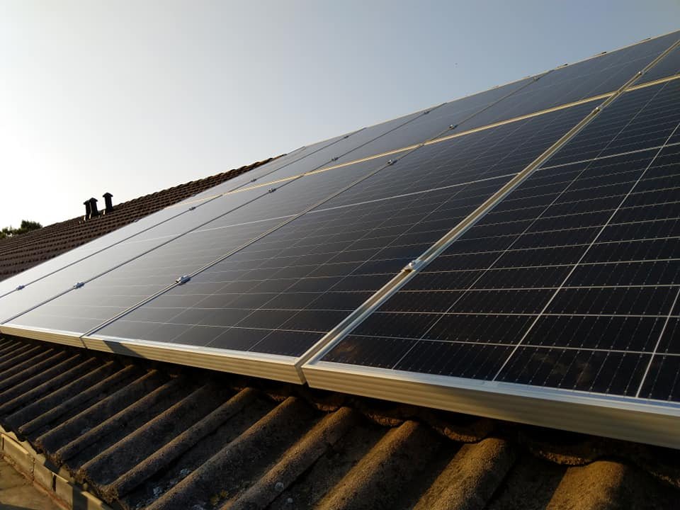 Dakvlak met zonnepanelen gefotografeerd in tegenlicht